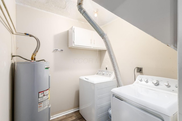 washroom featuring independent washer and dryer, electric water heater, dark wood-style floors, and baseboards