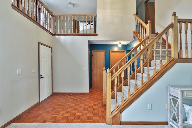 587 Center Woods Dr, Columbus, OH 43214 - stairway with a high ceiling and baseboards