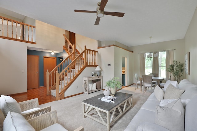 587 Center Woods Dr, Columbus, OH 43214 - living area with ceiling fan, stairs, carpet, and baseboards