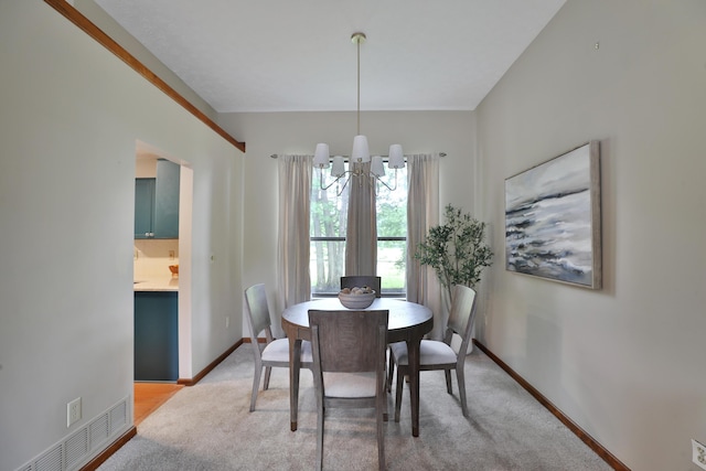 587 Center Woods Dr, Columbus, OH 43214 - dining area with a chandelier, light carpet, and baseboards