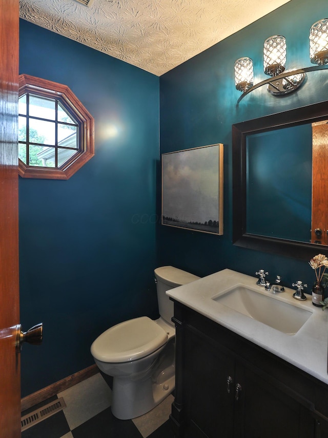 587 Center Woods Dr, Columbus, OH 43214 - bathroom with toilet, vanity, and a textured ceiling