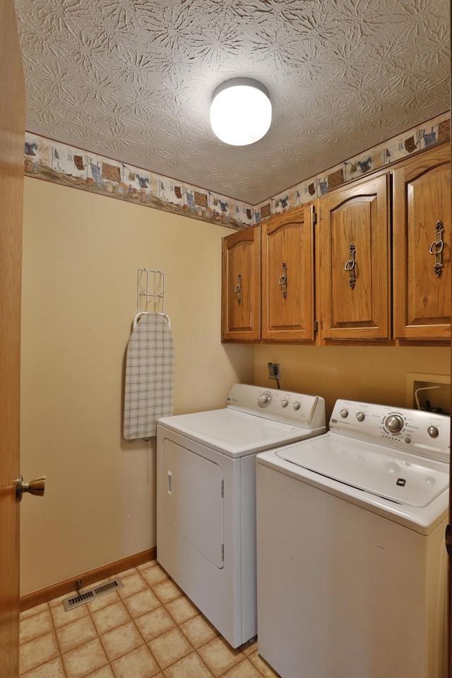 587 Center Woods Dr, Columbus, OH 43214 - laundry area with washing machine and dryer, cabinet space, and baseboards