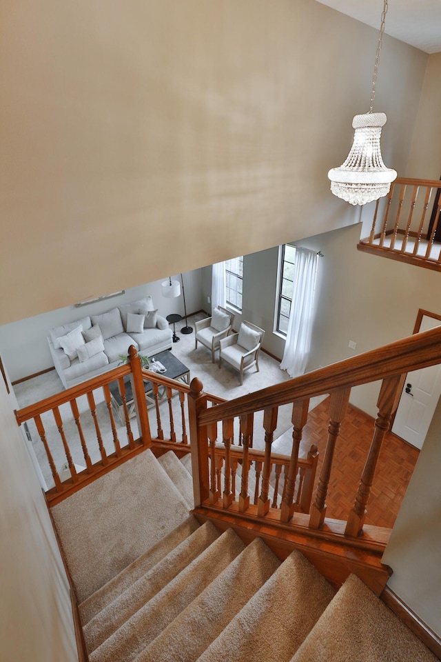 587 Center Woods Dr, Columbus, OH 43214 - stairs featuring carpet flooring and a chandelier