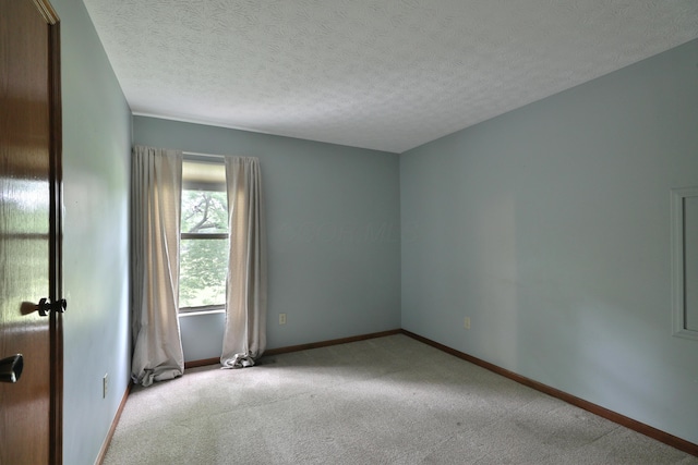 587 Center Woods Dr, Columbus, OH 43214 - carpeted spare room with baseboards and a textured ceiling