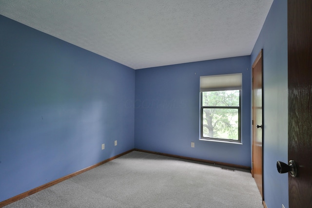 587 Center Woods Dr, Columbus, OH 43214 - carpeted spare room with baseboards and a textured ceiling