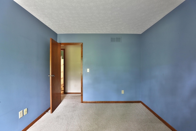 587 Center Woods Dr, Columbus, OH 43214 - spare room featuring a textured ceiling, carpet flooring, and baseboards