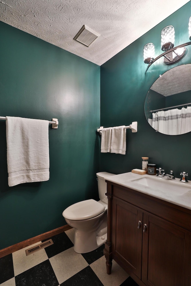 587 Center Woods Dr, Columbus, OH 43214 - bathroom featuring tile patterned floors, toilet, vanity, a textured ceiling, and baseboards