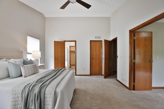 587 Center Woods Dr, Columbus, OH 43214 - bedroom featuring a towering ceiling, light colored carpet, baseboards, and a ceiling fan