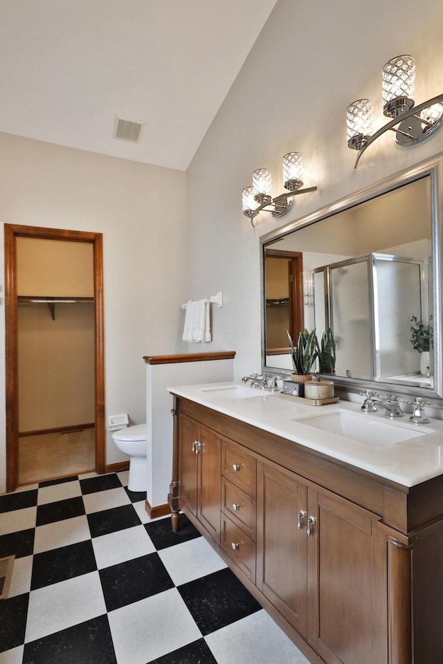 587 Center Woods Dr, Columbus, OH 43214 - full bath featuring vaulted ceiling, tile patterned floors, a shower stall, toilet, and double vanity