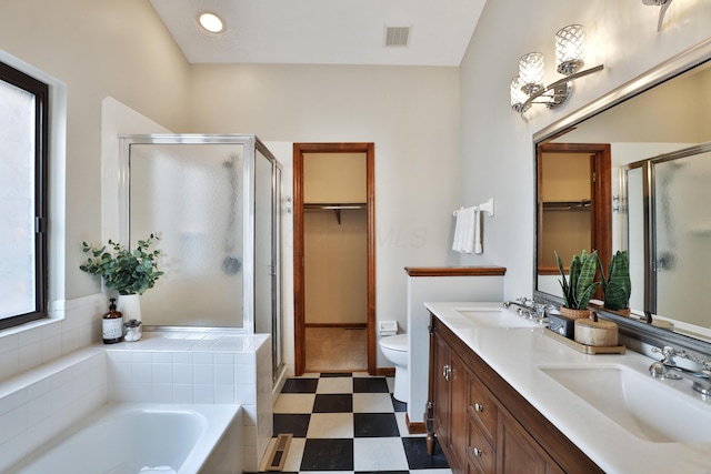 587 Center Woods Dr, Columbus, OH 43214 - bathroom featuring a stall shower, tile patterned floors, a walk in closet, and double vanity