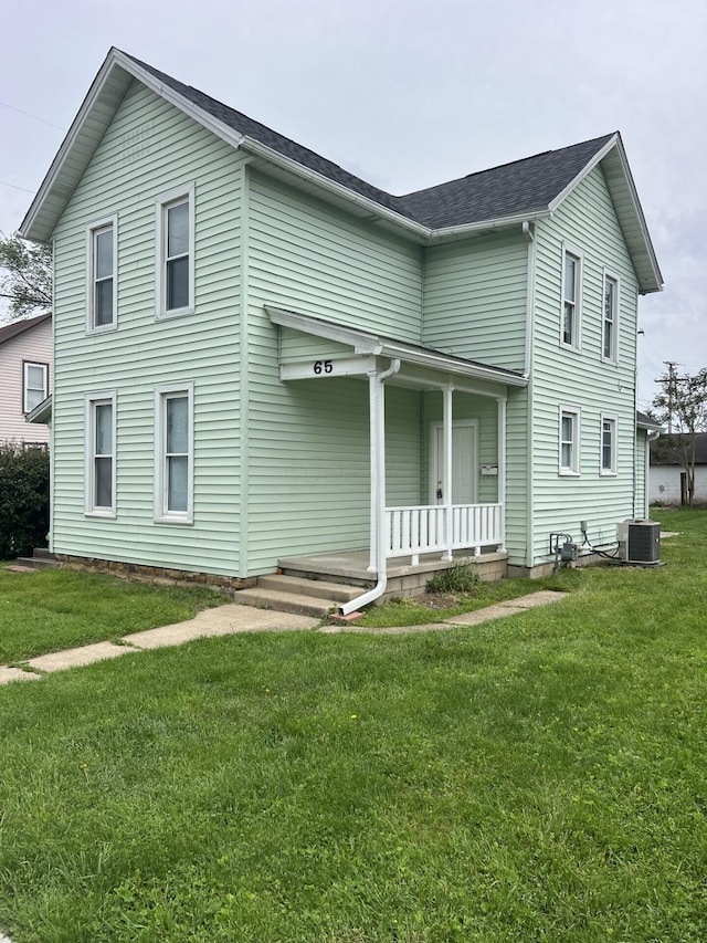 65 E N St, Newark, OH 43055 - view of front facade featuring a porch, central AC unit, a front yard, and a shingled roof