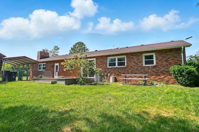 3865 Anderson Rd, Circleville, OH 43113 - back of property with a detached carport, a chimney, brick siding, and a yard