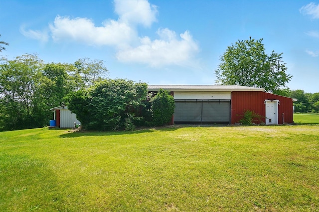 3865 Anderson Rd, Circleville, OH 43113 - view of green lawn featuring a detached garage and an outdoor structure