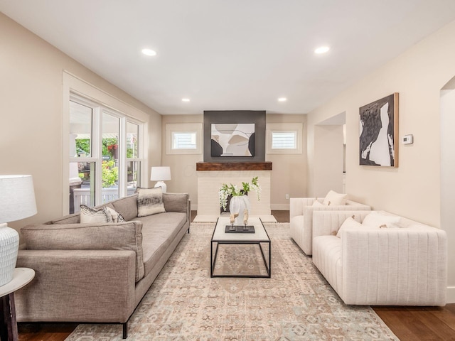 697 Stanley Ave, Columbus, OH 43206 - living area with wood finished floors, plenty of natural light, recessed lighting, baseboards, and a brick fireplace