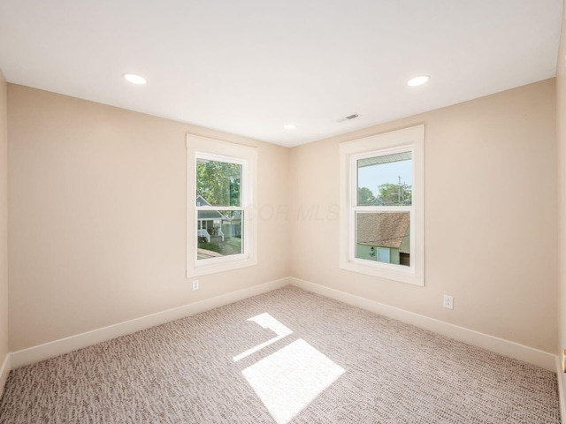 697 Stanley Ave, Columbus, OH 43206 - carpeted empty room with healthy amount of natural light, baseboards, and recessed lighting