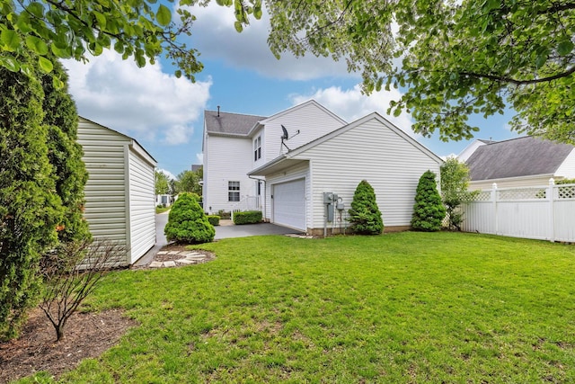 back of property with an attached garage and asphalt driveway