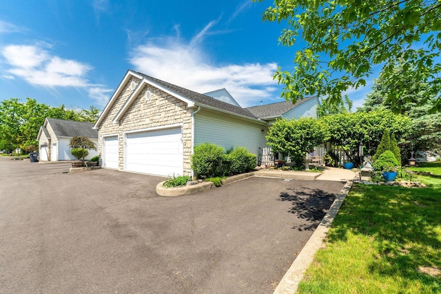 4642 Hobson Dr Unit 13E, Columbus, OH 43228 - view of front facade featuring stone siding, a garage, and a front yard