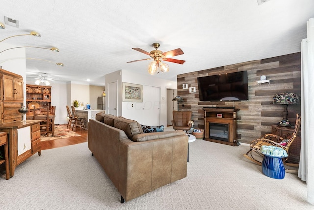 4642 Hobson Dr Unit 13E, Columbus, OH 43228 - carpeted living room with a ceiling fan, a glass covered fireplace, and wood walls