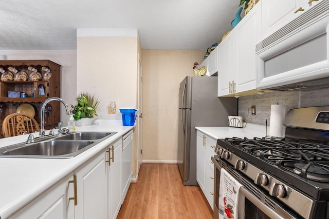 4642 Hobson Dr Unit 13E, Columbus, OH 43228 - kitchen with white appliances, a sink, light countertops, white cabinetry, and a textured ceiling