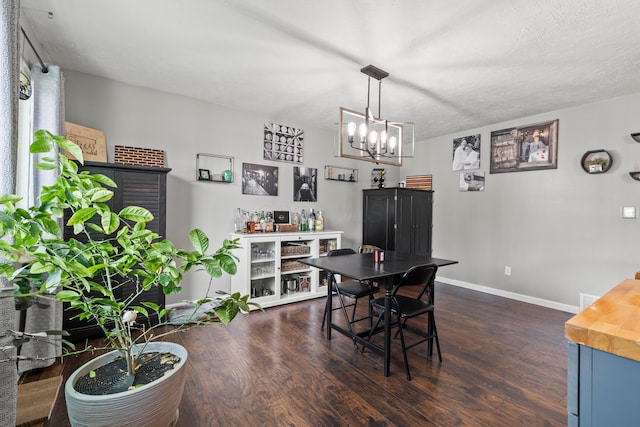 2923 Falcon Bridge Dr, Columbus, OH 43232 - dining area with dark wood finished floors, a chandelier, and baseboards