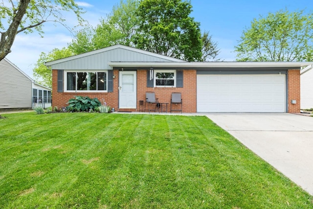 2923 Falcon Bridge Dr, Columbus, OH 43232 - view of front of home featuring brick siding, an attached garage, concrete driveway, and a front yard