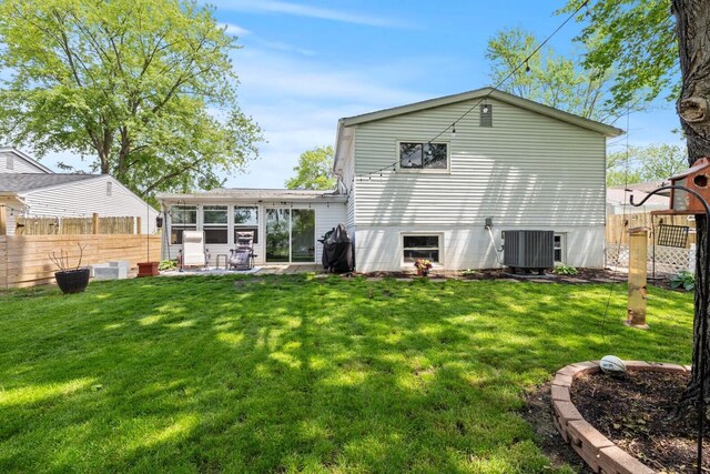 2923 Falcon Bridge Dr, Columbus, OH 43232 - back of house with a sunroom, central air condition unit, and a patio