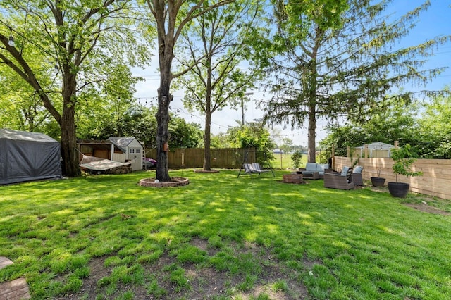 2923 Falcon Bridge Dr, Columbus, OH 43232 - view of yard featuring a storage unit, an outdoor living space, and an outbuilding