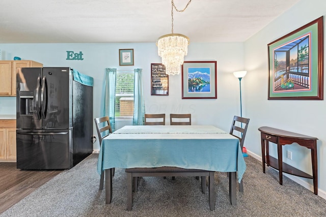 145 Sara Ave, Marion, OH 43302 - dining area featuring a chandelier, baseboards, and dark wood-style flooring