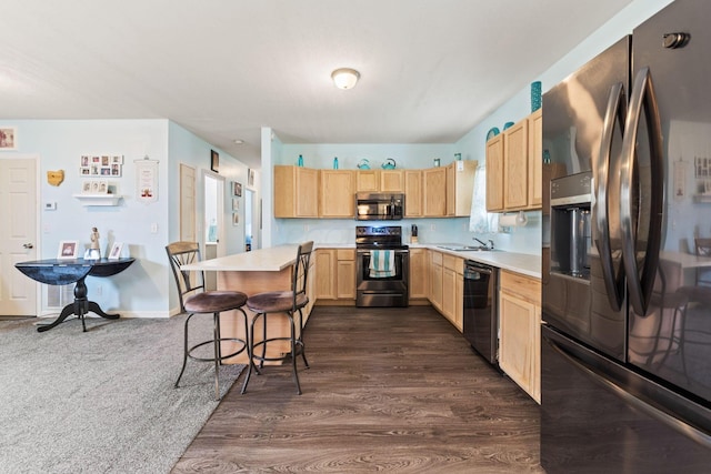 145 Sara Ave, Marion, OH 43302 - kitchen with appliances with stainless steel finishes, light brown cabinets, light countertops, a breakfast bar, and a sink