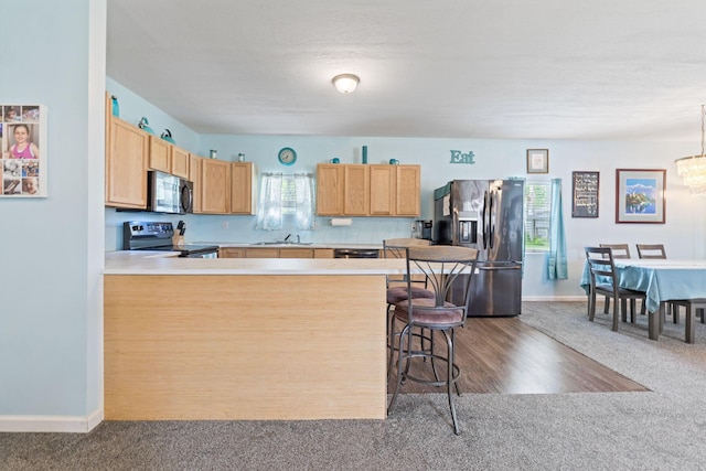 145 Sara Ave, Marion, OH 43302 - kitchen featuring appliances with stainless steel finishes, dark colored carpet, a sink, and light countertops