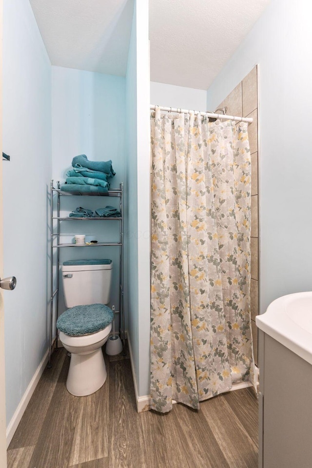 145 Sara Ave, Marion, OH 43302 - full bathroom with wood finished floors, a shower with shower curtain, toilet, and baseboards