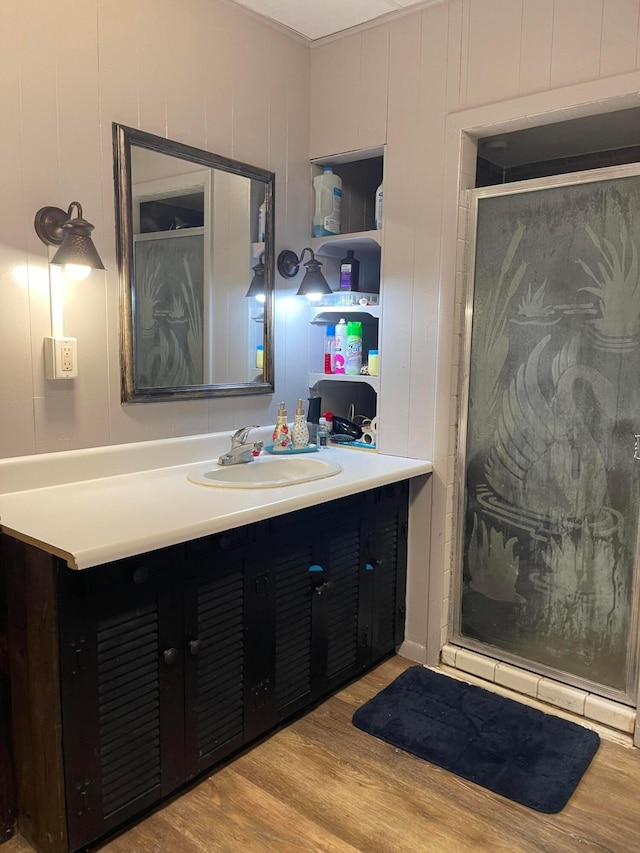 130 N 4th St, Greenfield, OH 45123 - bathroom featuring wood finished floors, a stall shower, vanity, and a decorative wall