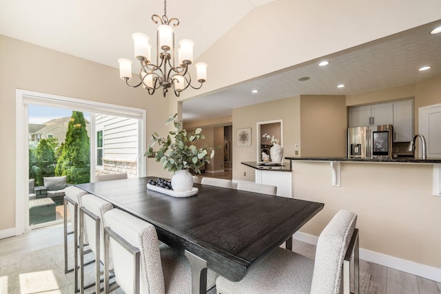 7834 Avaleen Cir N, Dublin, OH 43016 - dining room with light wood-style floors, a chandelier, recessed lighting, vaulted ceiling, and baseboards