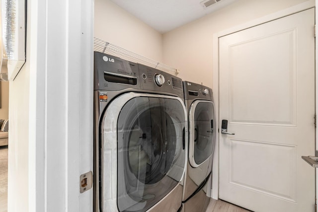 7834 Avaleen Cir N, Dublin, OH 43016 - laundry area featuring washer and clothes dryer and light wood finished floors