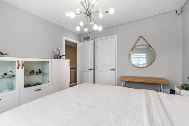 7834 Avaleen Cir N, Dublin, OH 43016 - bedroom featuring a chandelier and a textured ceiling