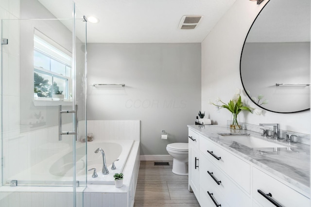 7834 Avaleen Cir N, Dublin, OH 43016 - bathroom with toilet, vanity, baseboards, a garden tub, and a shower stall