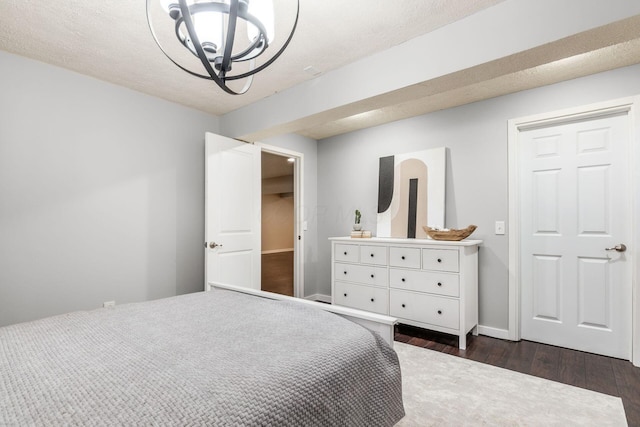 7834 Avaleen Cir N, Dublin, OH 43016 - bedroom featuring dark wood finished floors, a chandelier, and baseboards