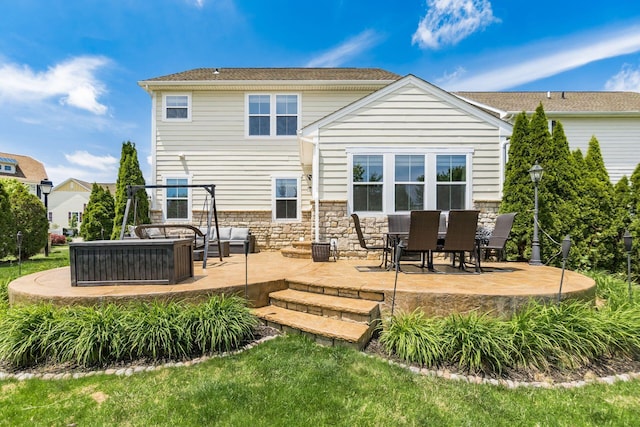 7834 Avaleen Cir N, Dublin, OH 43016 - rear view of property with a patio, stone siding, and outdoor lounge area