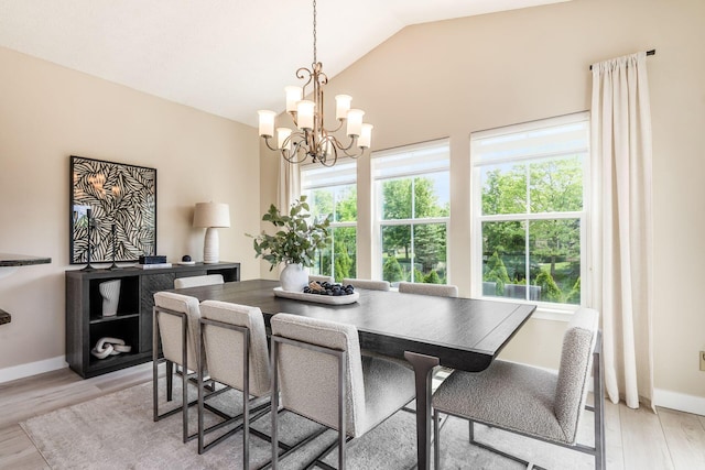 7834 Avaleen Cir N, Dublin, OH 43016 - dining area featuring a chandelier, light wood finished floors, lofted ceiling, and baseboards