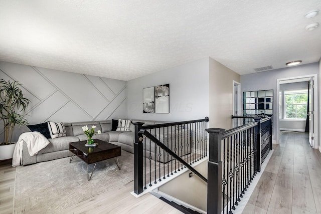7834 Avaleen Cir N, Dublin, OH 43016 - living area featuring wood finished floors, a textured ceiling, and baseboards