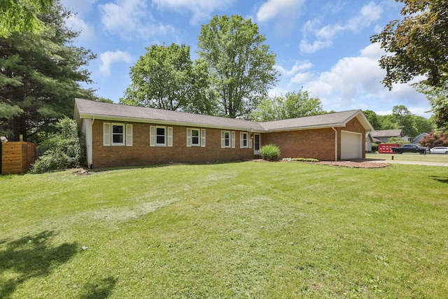 view of front of house featuring brick siding, a garage, and a front lawn