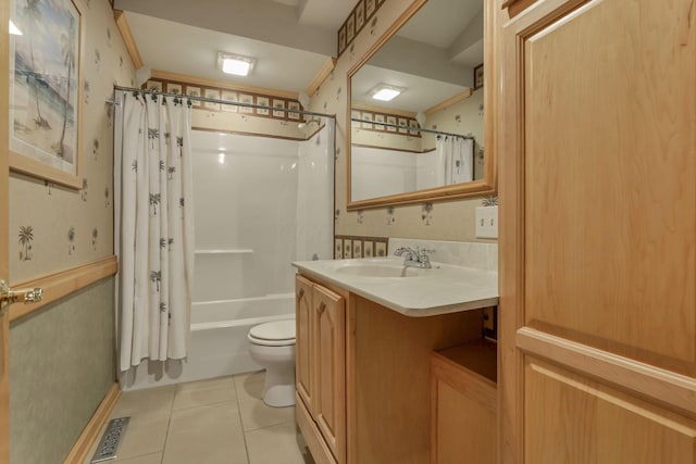 full bathroom with tile patterned floors, shower / bath combination with curtain, vanity, and toilet