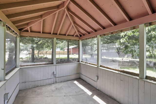 unfurnished sunroom featuring vaulted ceiling