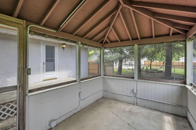 unfurnished sunroom with vaulted ceiling