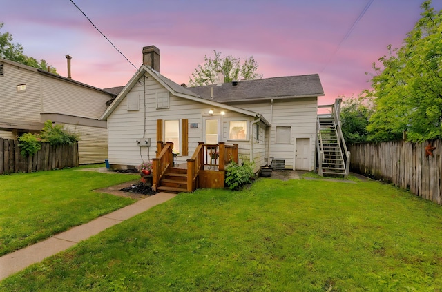 281 E Central Ave, Delaware, OH 43015 - back of house at dusk featuring stairs, a chimney, and a deck