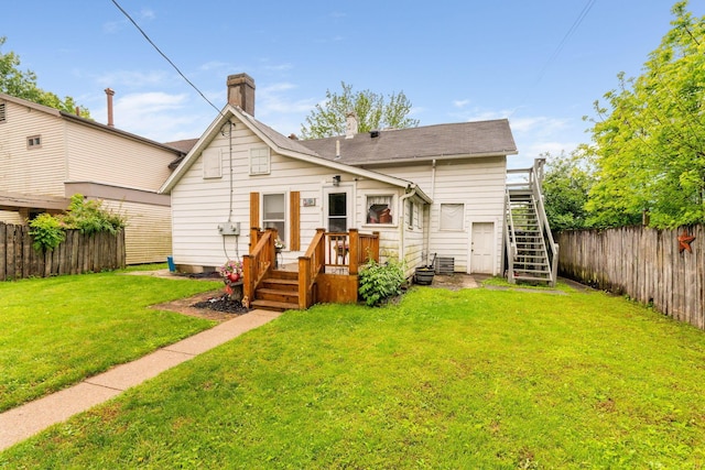 281 E Central Ave, Delaware, OH 43015 - back of property featuring stairs, a chimney, and a wooden deck