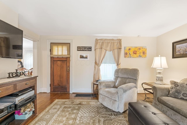 281 E Central Ave, Delaware, OH 43015 - living room featuring dark wood-type flooring and baseboards
