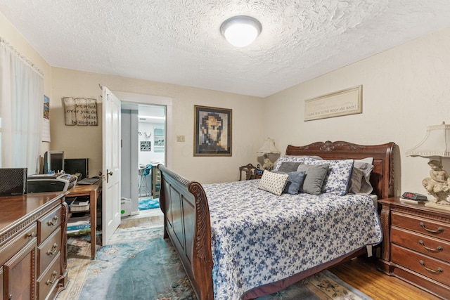 281 E Central Ave, Delaware, OH 43015 - bedroom with dark wood-type flooring, a textured ceiling, and an office area