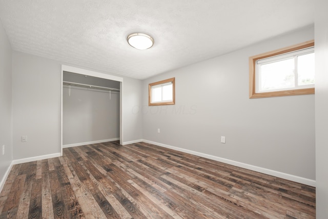 1366 Dyer Rd, Grove City, OH 43123 - unfurnished bedroom featuring wood finished floors, a closet, baseboards, and a textured ceiling