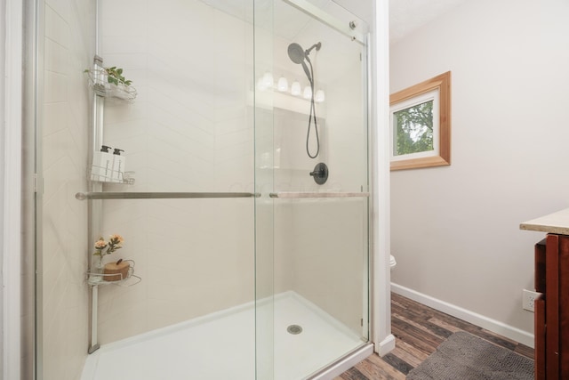 1366 Dyer Rd, Grove City, OH 43123 - full bathroom with wood finished floors, a shower stall, baseboards, and vanity